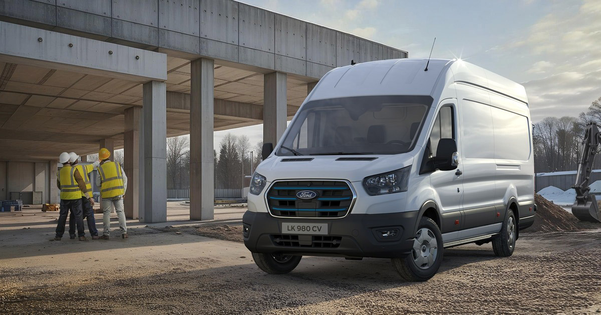 White Ford E-Transit electric van parked at construction site with workers in safety vests in background