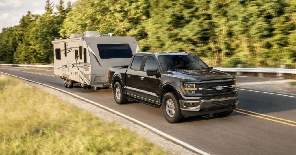 Towing a camper along a West Michigan road with a 2026 Ford F-150 at Borgman Ford in Grand Rapids, MI