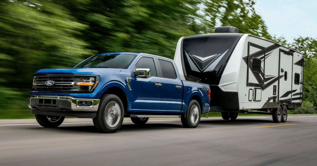 A 2026 Ford F-150 towing a camper along a West Michigan interstate highway